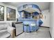 Finished basement featuring bar with mini fridge and seating for entertaining at 7610 S Garland St, Littleton, CO 80128