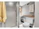 Efficient bathroom with a pedestal sink, modern toilet, and walk-in shower with glass door at 7610 S Garland St, Littleton, CO 80128