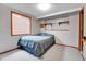 Cozy bedroom featuring a queen-sized bed, natural light, and convenient built-in shelving at 7610 S Garland St, Littleton, CO 80128