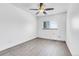 Bright bedroom featuring a ceiling fan and light grey wood-look flooring at 7610 S Garland St, Littleton, CO 80128