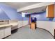 Bright, curved room with arcade game, storage and desk area, perfect for entertaining and hobbies at 7610 S Garland St, Littleton, CO 80128