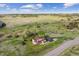 Spacious two-story house with a large backyard, lush green surroundings, and a private driveway at 7289 Stroh Rd, Parker, CO 80134