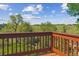 Enjoy beautiful views from this back deck with wood railing overlooking mature trees and greenery at 7289 Stroh Rd, Parker, CO 80134