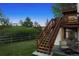 Beautifully landscaped backyard with stairs leading to a deck above at 7289 Stroh Rd, Parker, CO 80134