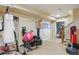 Finished basement fitness area featuring punching bag, workout equipment, and carpeted flooring at 7289 Stroh Rd, Parker, CO 80134