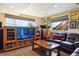 Cozy finished basement with a large screen TV, built-in shelves, and comfortable seating area at 7289 Stroh Rd, Parker, CO 80134