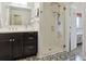 Bathroom featuring decorative tile flooring, frameless glass shower, and modern vanity at 7289 Stroh Rd, Parker, CO 80134