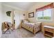 Bedroom featuring neutral colored walls, carpet and a wooden bed underneath a window at 7289 Stroh Rd, Parker, CO 80134