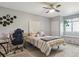 Bedroom with ceiling fan, window seat, gray walls, carpet, and a striped bed at 7289 Stroh Rd, Parker, CO 80134