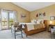Bedroom with neutral walls and decor, and doors leading to a balcony at 7289 Stroh Rd, Parker, CO 80134