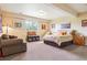 Large bedroom featuring lots of natural light, a seating area, and a comfortable bed at 7289 Stroh Rd, Parker, CO 80134