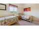 Bedroom featuring two twin beds, window and artwork on the wall creating a relaxing atmosphere at 7289 Stroh Rd, Parker, CO 80134