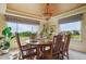 Elegant dining room featuring a chandelier, round wooden table, and scenic window views at 7289 Stroh Rd, Parker, CO 80134