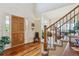 Welcoming foyer with hardwood floors, staircase, and a view of the living room at 7289 Stroh Rd, Parker, CO 80134