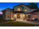 Charming front entrance with brick accents, a cozy seating area, and a well-manicured lawn at 7289 Stroh Rd, Parker, CO 80134