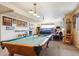 Finished basement game room with pool table, media area, and comfortable seating for entertaining at 7289 Stroh Rd, Parker, CO 80134