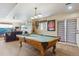 Finished basement game room featuring a pool table, leather seating and ample entertaining space at 7289 Stroh Rd, Parker, CO 80134