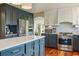 Spacious kitchen featuring stainless steel appliances, a central island, and stylish modern finishes at 7289 Stroh Rd, Parker, CO 80134