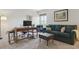 Living room with a desk and workstation, couch, ottoman and window providing natural light at 7289 Stroh Rd, Parker, CO 80134