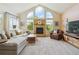 Bright living room features vaulted ceilings, large windows and a stone fireplace at 7289 Stroh Rd, Parker, CO 80134