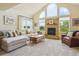 Comfortable living room features neutral color palette, large windows and a stone fireplace at 7289 Stroh Rd, Parker, CO 80134