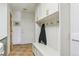 Mud room has storage, coat hooks, seating, and easy access to the home's exterior at 7289 Stroh Rd, Parker, CO 80134