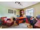 Well-lit home office with a comfortable reading chair and view at 7289 Stroh Rd, Parker, CO 80134