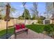 Charming backyard patio with seating, lush lawn, privacy fence, and storage shed at 9032 W Arizona Dr, Lakewood, CO 80232