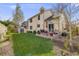 Expansive backyard with a well-maintained lawn, patio area, garden beds, and detached shed at 9032 W Arizona Dr, Lakewood, CO 80232