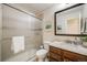 Bathroom featuring frosted glass shower door, vanity with a granite countertop, and wood cabinetry at 9032 W Arizona Dr, Lakewood, CO 80232