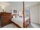 Bright bedroom with a four-poster bed, wooden furniture, and a window view of the outdoors at 9032 W Arizona Dr, Lakewood, CO 80232