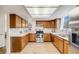 Well-lit kitchen with modern stainless steel appliances, wood cabinets, and countertops at 9032 W Arizona Dr, Lakewood, CO 80232
