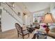 Open-concept living room with a staircase, hardwood floors, and ample natural light at 9032 W Arizona Dr, Lakewood, CO 80232