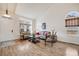 Bright living room featuring hardwood floors, large windows, and elegant seating arrangements at 9032 W Arizona Dr, Lakewood, CO 80232
