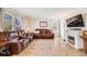 Relaxing living room with hardwood floors, cozy seating, and a fireplace at 9032 W Arizona Dr, Lakewood, CO 80232