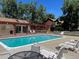 Community pool with lounge chairs, pergola, and landscaping, ideal for outdoor relaxation and recreation at 9032 W Arizona Dr, Lakewood, CO 80232