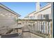 Balcony view showcasing an outdoor dining set, string lights, and surrounding neighborhood views at 8358 Pebble Creek Way # 204, Highlands Ranch, CO 80126