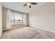 Bright bedroom with large windows, neutral walls, ceiling fan, and plush carpet at 8358 Pebble Creek Way # 204, Highlands Ranch, CO 80126