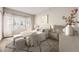Comfortable bedroom with plush bedding, stylish decor, and ample natural light at 8358 Pebble Creek Way # 204, Highlands Ranch, CO 80126