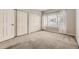 Bright bedroom features neutral carpeting, double closets, and a window with sheer curtains at 8358 Pebble Creek Way # 204, Highlands Ranch, CO 80126