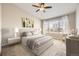 Bright bedroom with a ceiling fan, soft lighting, and a large window with outdoor views at 8358 Pebble Creek Way # 204, Highlands Ranch, CO 80126
