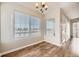 Bright dining area featuring hardwood floors, large windows, and stylish lighting fixture at 8358 Pebble Creek Way # 204, Highlands Ranch, CO 80126