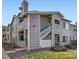 Charming townhome exterior with multiple balconies and gray siding at 8358 Pebble Creek Way # 204, Highlands Ranch, CO 80126