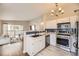 Stylish kitchen with stainless steel appliances and a view to living room and balcony at 8358 Pebble Creek Way # 204, Highlands Ranch, CO 80126