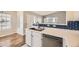 Charming kitchen featuring white cabinets, stainless steel appliances, and a blue tile backsplash at 8358 Pebble Creek Way # 204, Highlands Ranch, CO 80126