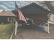 Car parked in rustic carport with USA flag, providing shelter and country charm at 110 S Hoyt St, Lakewood, CO 80226