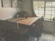 Dining area featuring wood table and chair set, illuminated by natural light from the window at 110 S Hoyt St, Lakewood, CO 80226