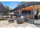 Charming covered patio with comfortable seating, a fire pit, and an outdoor kitchen area at 110 S Hoyt St, Lakewood, CO 80226