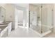 This bathroom features an oversized glass shower with bench and modern fixtures at 3856 Treadway Pt, Castle Rock, CO 80108