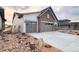 Charming home featuring a two-car garage, and professionally landscaped front yard with rock accents at 3856 Treadway Pt, Castle Rock, CO 80108